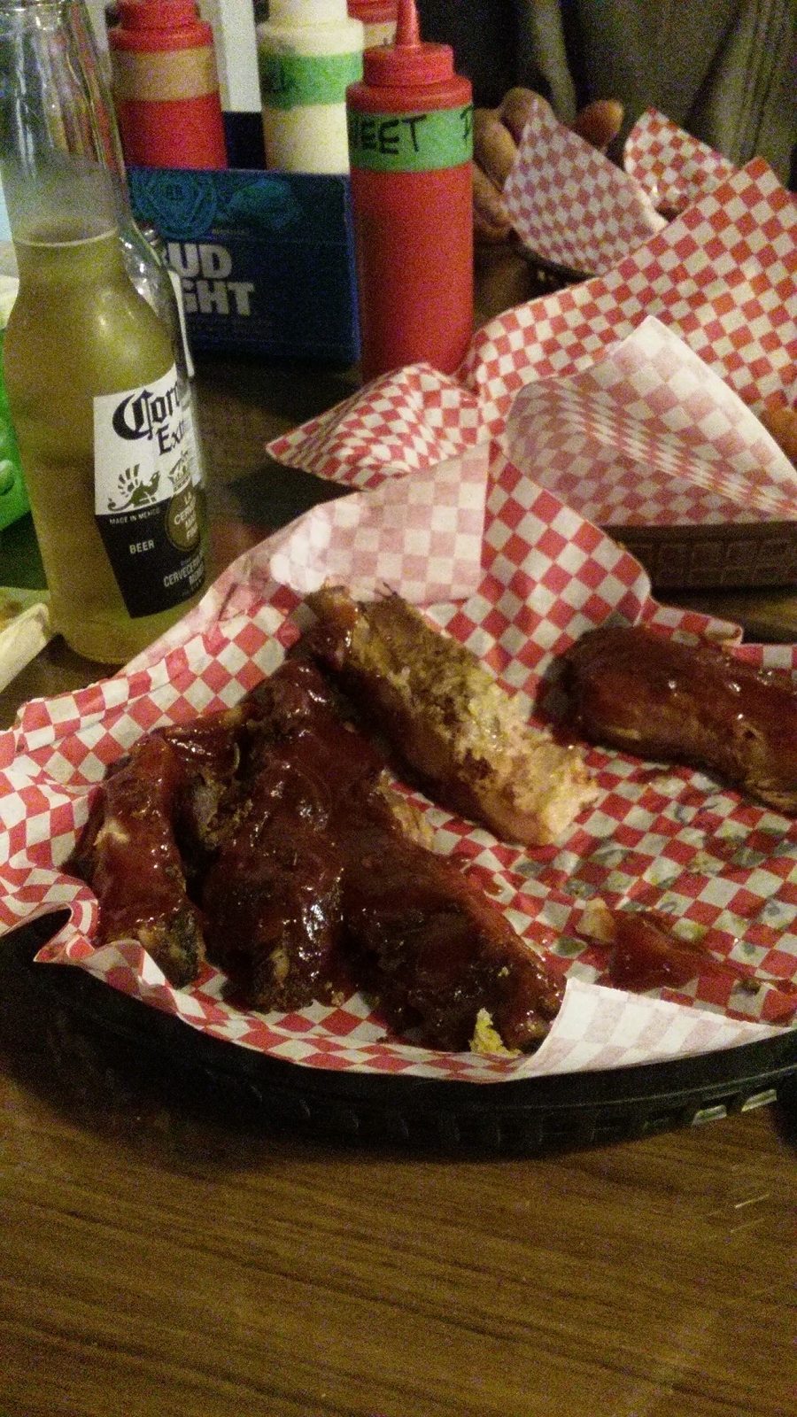 Basket of sauced ribs with a cold beer