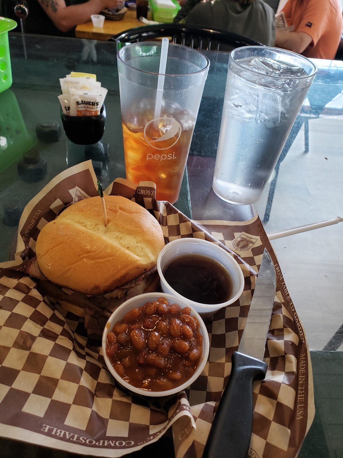 Smoked meat sandwich with a side of baked beans